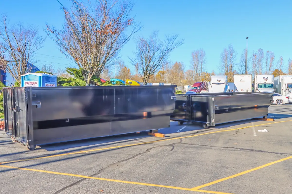 Professional dumpster rental service with roll-off container on residential driveway in London Grove